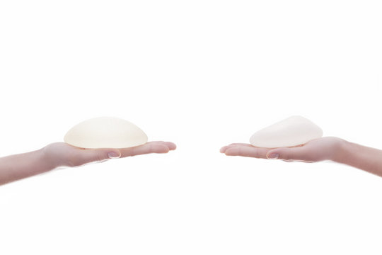 Two different Silicone breast implant on hands