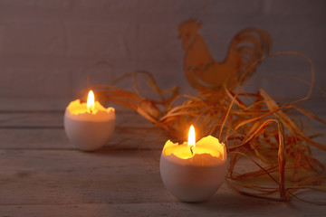 Rustic composition with candles and eggs. Happy easter. Selective focus.