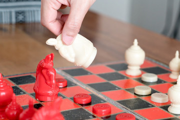 the white chess on women hand is fighting with red, think, discuss, committed, competition, winner,...