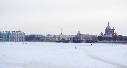 Fototapeta na wymiar Dangerous ice on the river. People walk on the dangerous ice of the frozen Neva river. Saint-Petersburg. Russia. 