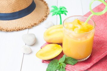 Tropical summer smoothie, Mango smoothie on wooden table, Summer lifestyle concept
