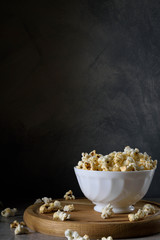 Air salty popcorn.A bowl of popcorn on a wooden table. Rustic style.