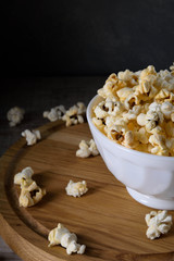 Air salty popcorn.A bowl of popcorn on a wooden table. Rustic style.