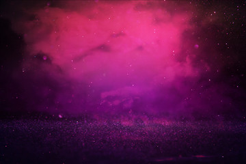 Purple and pink glitter lights background. defocused.