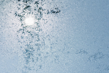 Winter texture. Frosts on the glass. Frosty day Sunset on the winter day through the window.