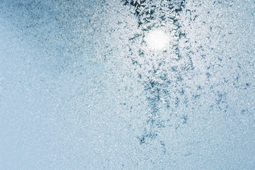 Winter texture. Frosts on the glass. Frosty day Sunset on the winter day through the window.
