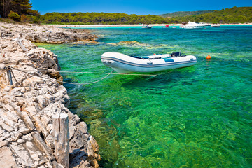 Idyllic rocky beach Sakarun and small boat on Dugi Otok island