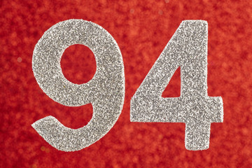 Number ninety-four silver color over a red background. Anniversary