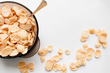 delicious crispy cornflakes in bowl on white background,  healthy breakfast