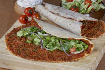 Turkish Food: lahmacun closeup on a wooden table. Horizontal
