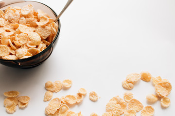 delicious crispy cornflakes in bowl on white background,  healthy breakfast