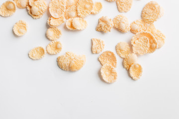 Round frame of delicious crispy cornflakes on white background, healthy breakfast