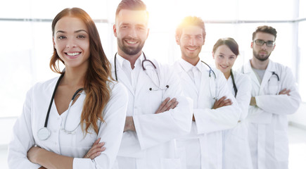 Portrait of medical team standing with arms crossed in hospital