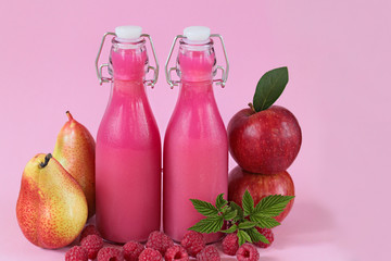 fruit smoothies. Healthy smoothie . Pink smoothies made from fresh apples, pears and berry raspberries on a bright pink background. 