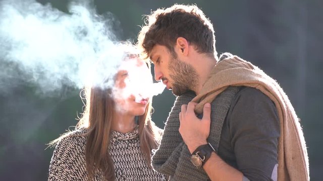 Man smoking near his girlfriend