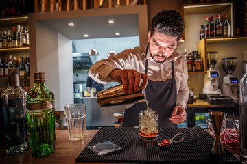Male bartender is making cocktail