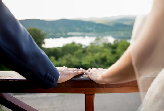 Fresh wedding couple - bride and husband hand together