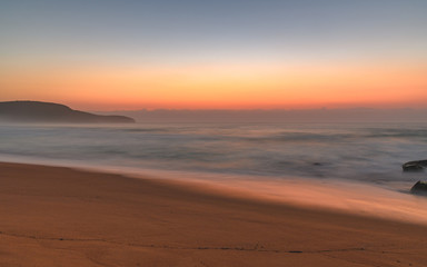 Fototapeta na wymiar Hazy Sunrise Seascape with Rocks