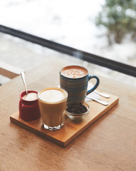 Fototapeta na wymiar Hot coffee with milk in table in coffee shop