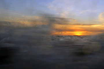 Fototapeta na wymiar SUNSET OVER THE SEA