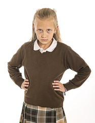 7 or 8 years old sad and frustrated  schoolgirl female child in uniform suffering bullying or...