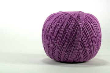 lilac tangle of natural cotton thread for needlework on white background close-up