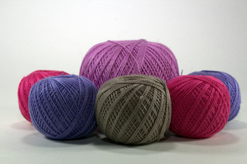 multi-colored natural cotton balls on a white background