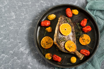 Flounder baked with mandarins and cherry tomatoes