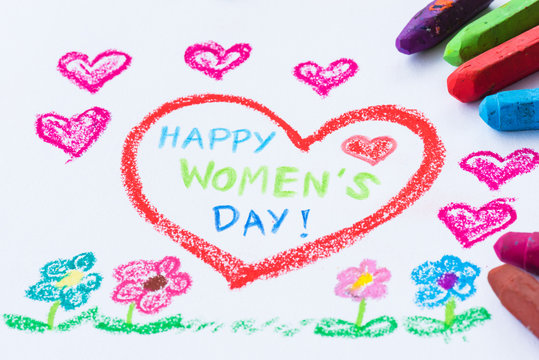 Pencil color drawing Happy Women's Day on white paper with paper star. Womens Day concept.