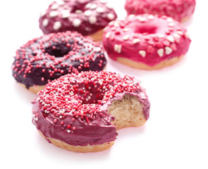 Delicious colorful donuts on white background