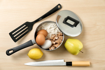 Set of kitchenware and products on wooden background. Cooking master classes