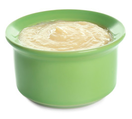 Tasty vanilla pudding in ramekin on white background