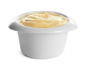 Tasty vanilla pudding in ramekin on white background