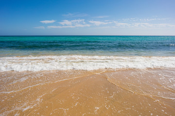 wave of blue ocean on sandy beach. Background.