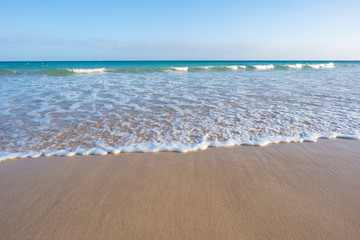 closeup of sand on beach and blue summer sky