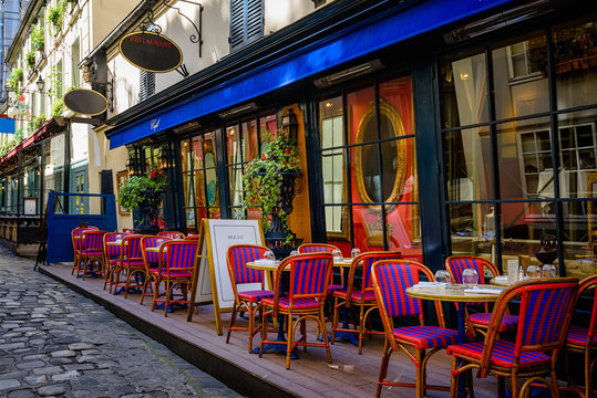 Cozy street with tables of cafe in Paris, France
