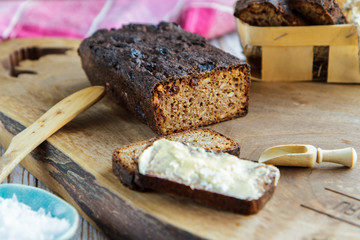 Piece of rye bread with butter on a cutting board