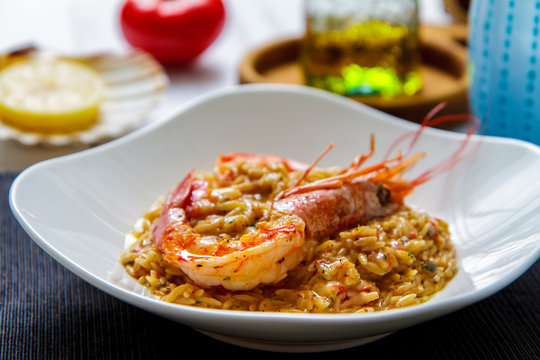 Italian rizoni pasta with large shrimps side view