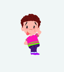 Boy in shirt sticks out his tongue in gesture of funny shyness.