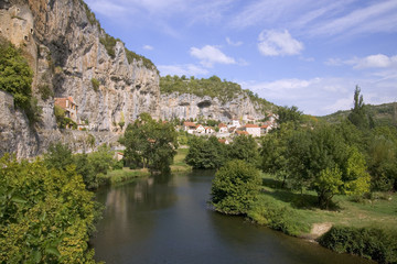 Fototapeta na wymiar Europe, France, Quercy, Lot, Quaint village houses sit between the cliffs and the River Cele in Cabrerets