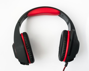 black gaming headphones with cord on white background