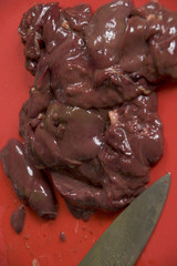Raw chicken livers on a chopping board
