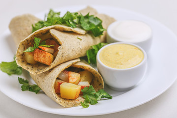 Vegetarian masala dosa with potato, chutney and sambar sauces.
