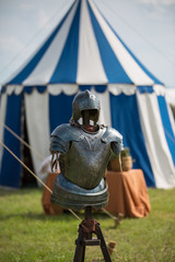 Medieval Metallic Armor and Ancient Tent in background