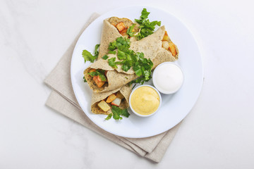 Vegetarian masala dosa with potato, chutney and sambar sauces.