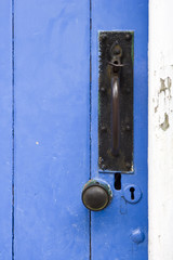 Old blue painted outbuilding door, latch and knob