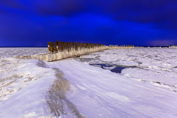 Frozen coastline of Baltic Sea in Gdynia at night, Poland