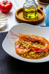 Italian rizoni pasta with big shrimps close-up