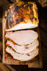 Roasted pork loin on the old wooden table - 195308516