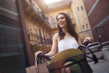 Fototapeta na wymiar Portrait of beautiful young woman enjoying time on bicycle